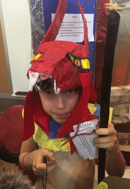 Isa's son in a red jackal headdress